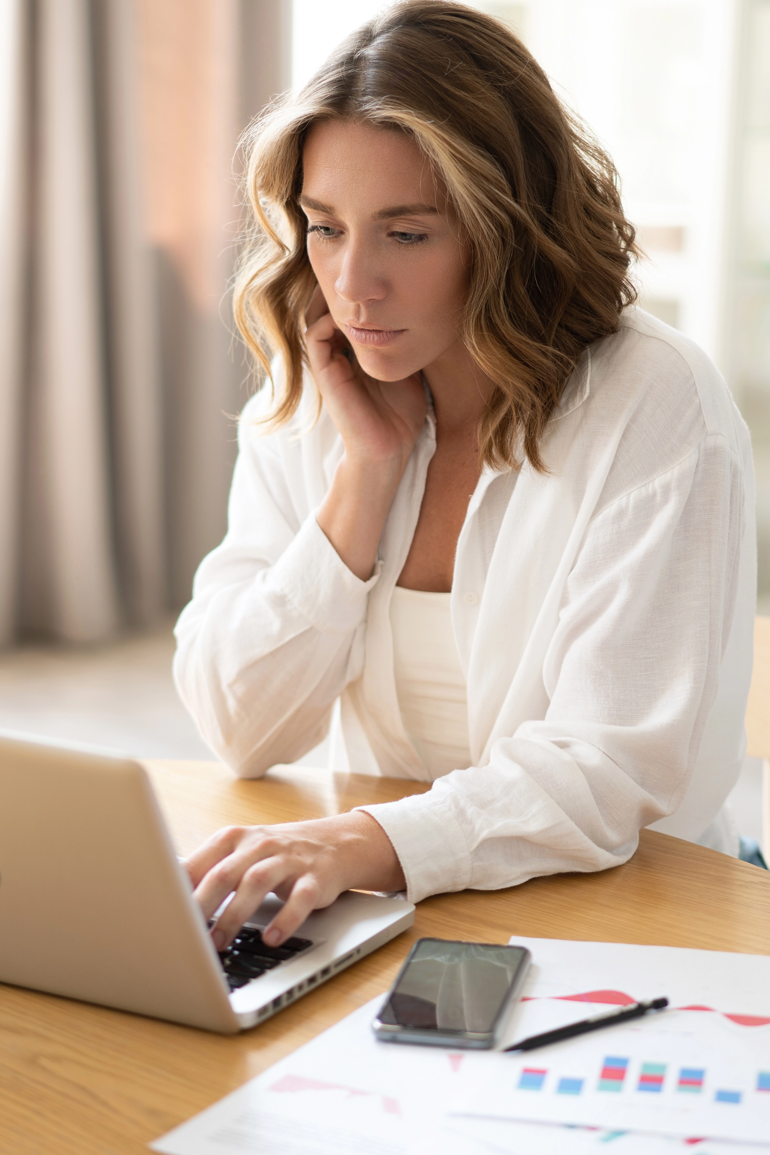 Woman reviewing finances on laptop